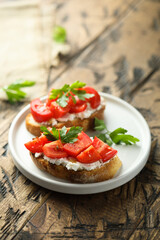 Homemade bruschetta with cream cheese and tomato