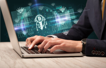 business hand working in stock market with blockchain icons coming out from laptop screen