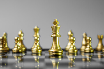 Gold Chess figure team (King, Queen, Bishop, Knight, Rook and Pawn) on Chessboard against opponent during battle. Strategy, Success, management, business planning, tactic, politic and leader concept
