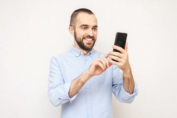 Bearded uses phone, white background, copy space