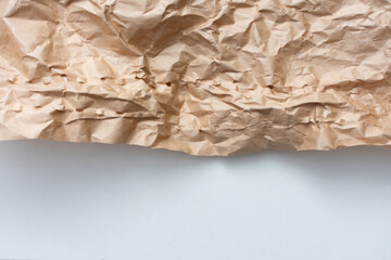 Crumpled craft paper, texture, white background, copy space