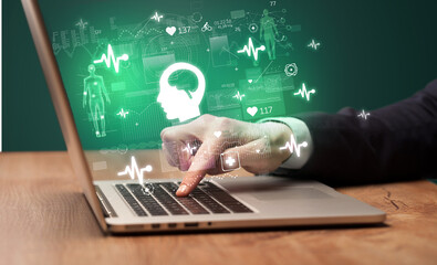 hand browsing on the internet for medical issues with brain icons coming out from the screen