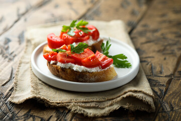 Homemade bruschetta with cream cheese and tomato