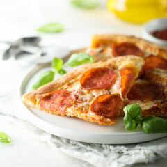 Traditional pepperoni pizza with fresh basil