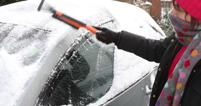 Woman removing snow from a Car , Woman Scraping Windshield, Lady removing snow from windshield with snow brush