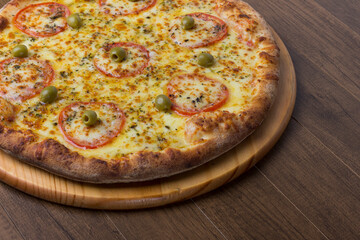ricardo fernando franca junior pizza mussarela muçarela mucarelMozzarella cheese pizza with slices of red tomatoes on a wooden board. Close-up photography. Space on the right for texts