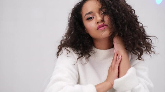 Camera zoom on attractive mixed race girl with afro hair and fresh make up. Natural beauty and youth concept