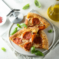 Traditional pepperoni pizza with fresh basil