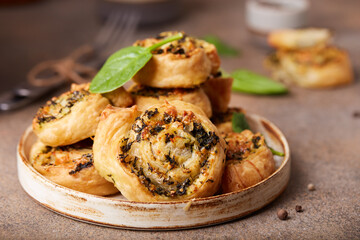 Delicious homemade puff pastry Pizza rolls with spinach, chicken meat and cheese 