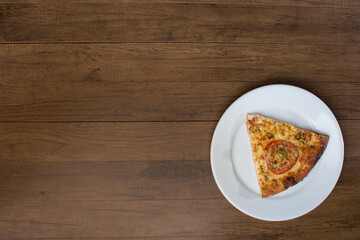 ricardo fernando franca junior pizza mussarela muçarela mucarelTasty slice of mozzarella cheese pizza with slices of red tomatoes, served on a plate. Top photograph with upper left space for texts.