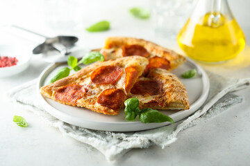 Traditional pepperoni pizza with fresh basil