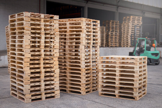 Stack of wooden pallets rack at warehouse storage.