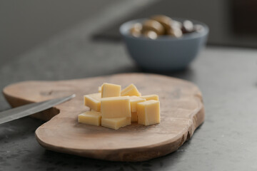 Pieces of hard vintage cheese on wood olive board