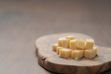 Pieces of hard vintage cheese on wood olive board