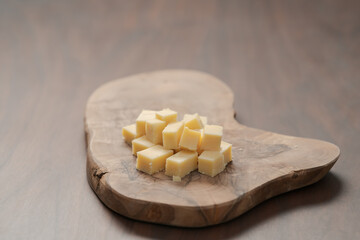 Pieces of hard vintage cheese on wood olive board