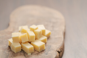 Pieces of hard vintage cheese on wood olive board