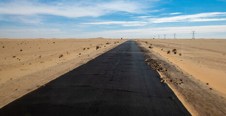 black tarmac road through sand desert in Mauritania