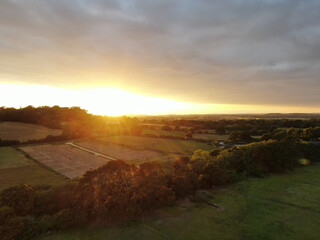 aerial view of beautiful rolling countryside at sunset with a golden light