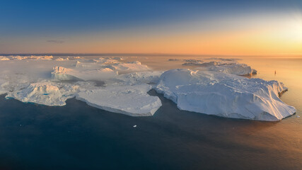 floating glaciers in the rays of the setting sun during a polar night