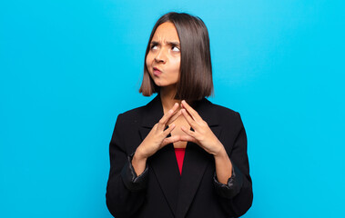 hispanic woman scheming and conspiring, thinking devious tricks and cheats, cunning and betraying