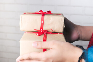 women hand holding stack of gift box 