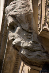 a carved stone head on the side of a building