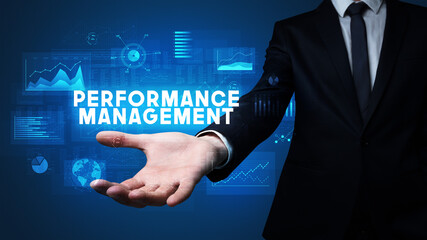 Hand of Businessman holding PERFORMANCE MANAGEMENT inscription, business success concept