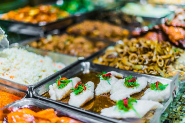 Traditional Asian dishes sold in a food court in Singapore