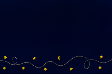 White thread and yellow stars on a dark blue background