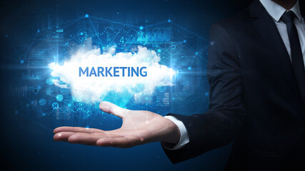 Hand of Businessman holding MARKETING inscription, successful business concept