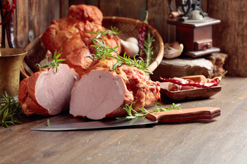 Smoked ham on an old wooden table.