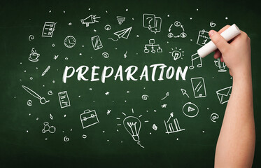 Hand drawing PREPARATION inscription with white chalk on blackboard, education concept