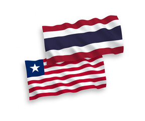 National vector fabric wave flags of Liberia and Thailand isolated on white background. 1 to 2 proportion.