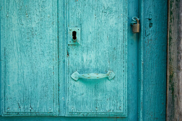 Old doors in colors and with aged paint.