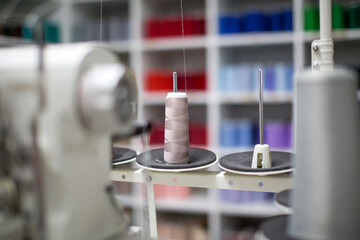 Professional overlock sewing machine. Equipment for edging, hemming or seaming clothes at tailors shop.