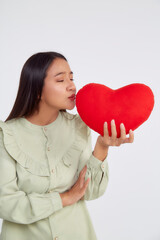 young attractive woman holding a red heart