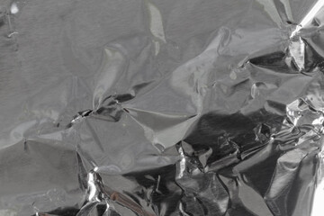Shiny crumpled silver aluminum foil closeup. Background.