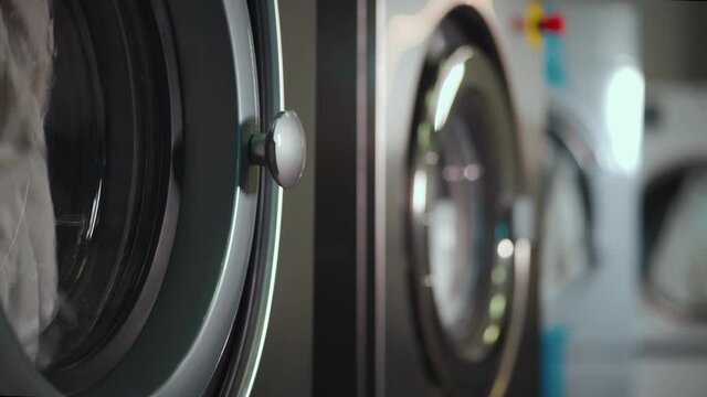 washing machine and dryer working at professional industrial laundry