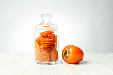 persimmon fruit and bottle with chips