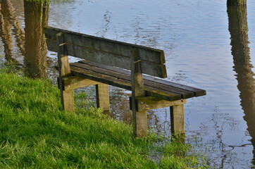 The public bench and the swollen river.