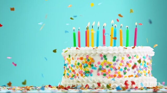 Birthday Cake With Burning Colorful Candles on Pastel Blue Background. Super Slow Motion, 1000 FPS.