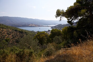 Fototapeta na wymiar View from the mountain to a small town and nature on the island of Poros. Greece. Panorama.