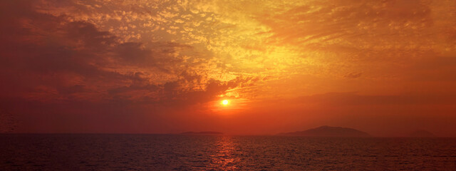 Ultra wide panoramic breathtaking sunset from famous Querini castle on top of Astypalaia island main village, Dodecanese, Greece