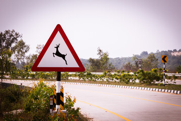 Indian road sign indicating deer crossing. Sign indicating to watch out for wildlife like deer as the road pass through reserve forest