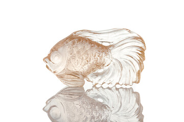 beautiful figurine fish made of topaz on a white background