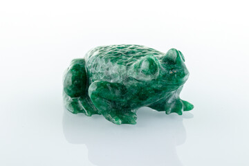 beautiful figurine of a toad made of malachite on a white background