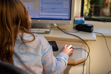 Child working at home during lockdown as children need to home school via online learning