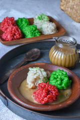 Putu Mayang. Traditional Javanese snack of rice flour strands curled up into a ball; served with coconut milk and palm sugar