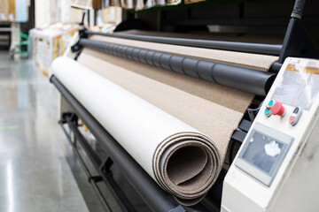 Machine for cutting and measuring carpets. A large roll of textile flooring prepared for marking...