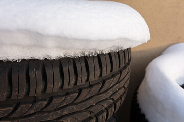 Old tires under white snow.